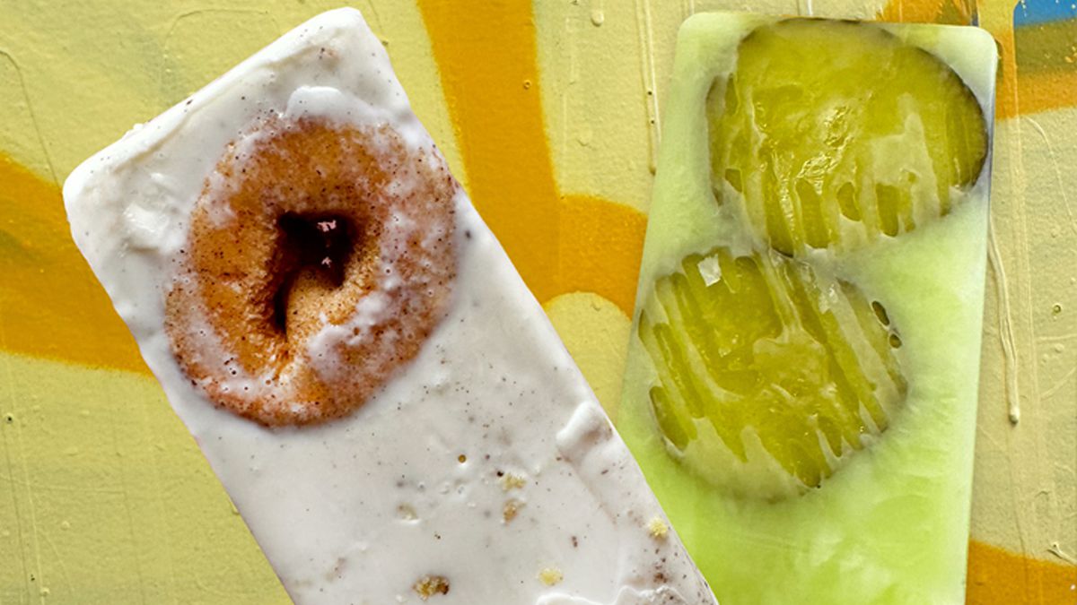A creamy, white popsicle with a mini doughnut frozen inside next to a bright, light green-yellow popsicle with two frozen dill pickles inside.