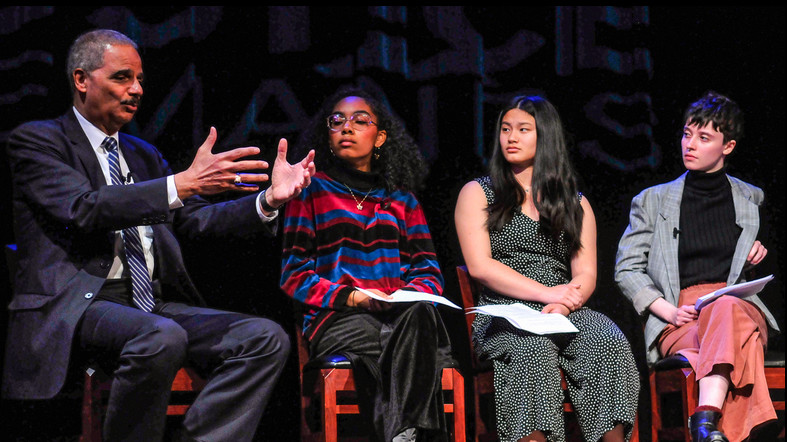 Eric Holder talks with Evanston Township High School students Trinity Collins, Emma Barreto and Clare Peterson, members of their school’s SOAR group (Students Organized Against Racism), which this year helped the Moran Center and Northwestern University o