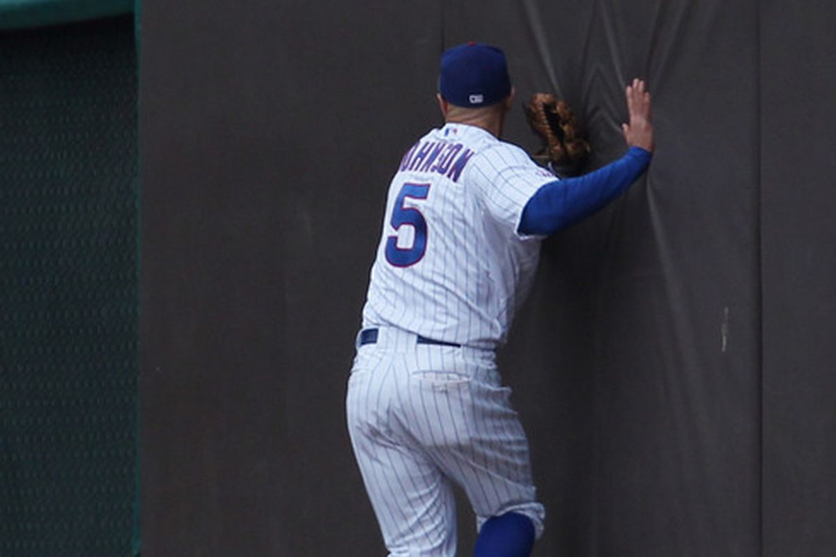 Reed Johnson of the Chicago Cubs hits the outfield wall trying to make a catch against the San Francisco Giants at Wrigley Field on May 13, 2011 in Chicago, Illinois. The Cubs defeated the Giants 11-4. (Photo by Jonathan Daniel/Getty Images)