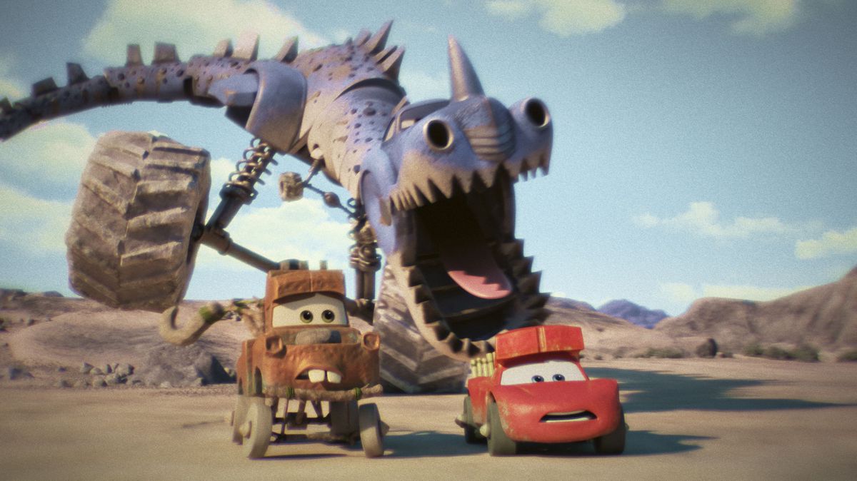 a large t-rex-like car creature chases a prehistoric looking mater and lightning mcqueen. the t-rex creature’s giant maws gape open as the two heroes race away towards the camera