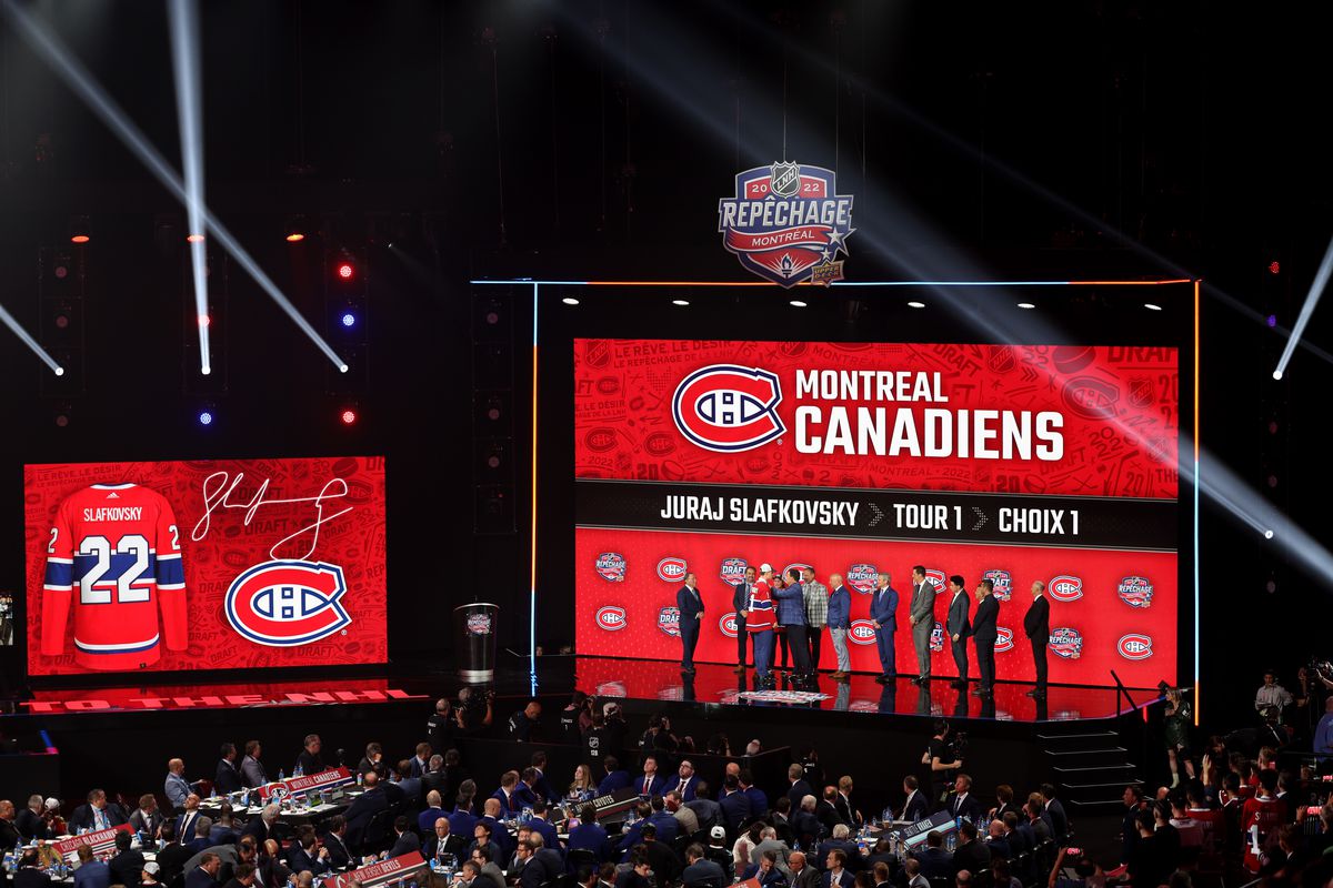 A general view of Juraj Slafkovsky of the Montreal Canadiens, first overall pick of the 2022 Upper Deck NHL Draft, shaking hands with team personnel onstage at Bell Centre on July 07, 2022 in Montreal, Quebec.