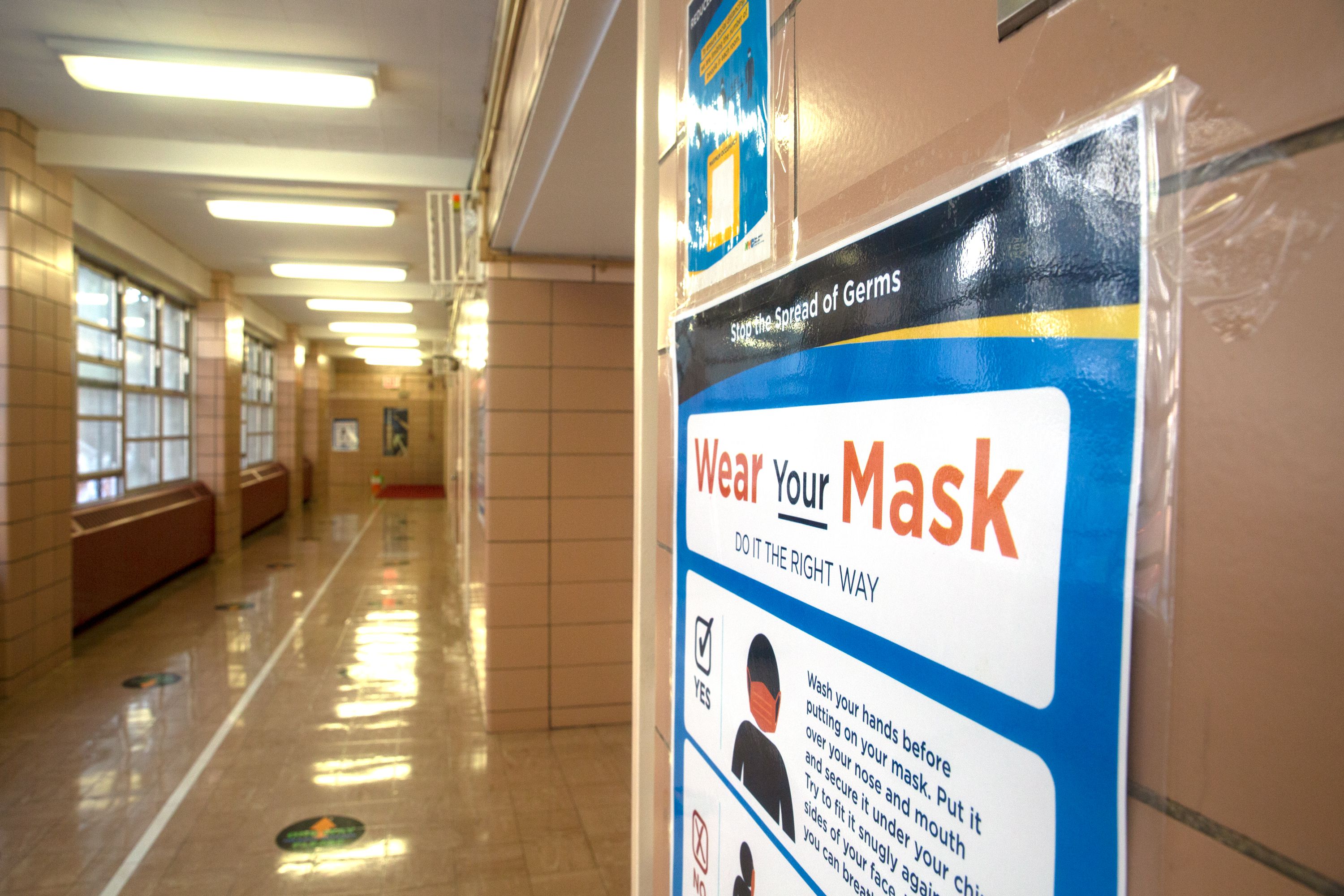 A sign on the wall at P.S. 179 in the South Bronx urges students to wear masks, Dec. 17, 2021.