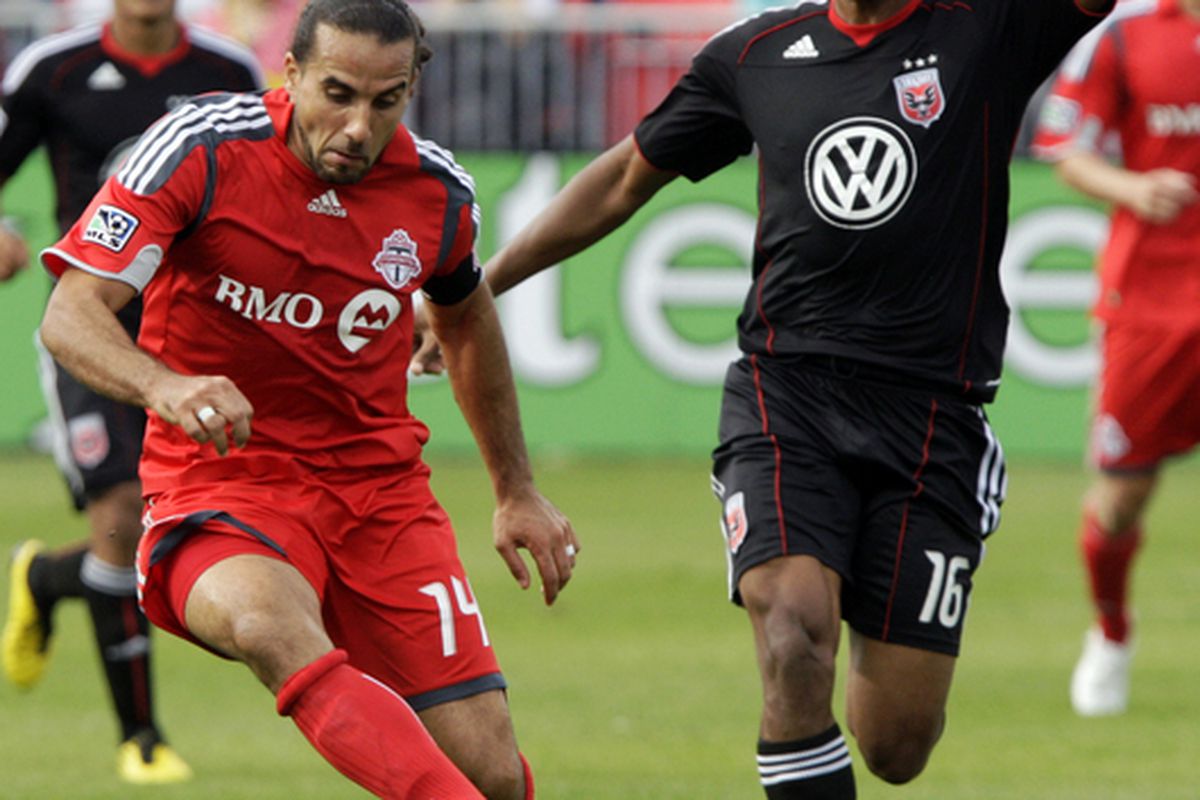 TORONTO CANADA - SEPTEMBER 28: Dwayne De Rosario #14 of Toronto FC battles for the ball with Jordan Graye #16 of D.C. United during a MLS game at BMO Field September 11 2010 in Toronto Ontario Canada. (Photo by Abelimages/Getty Images)