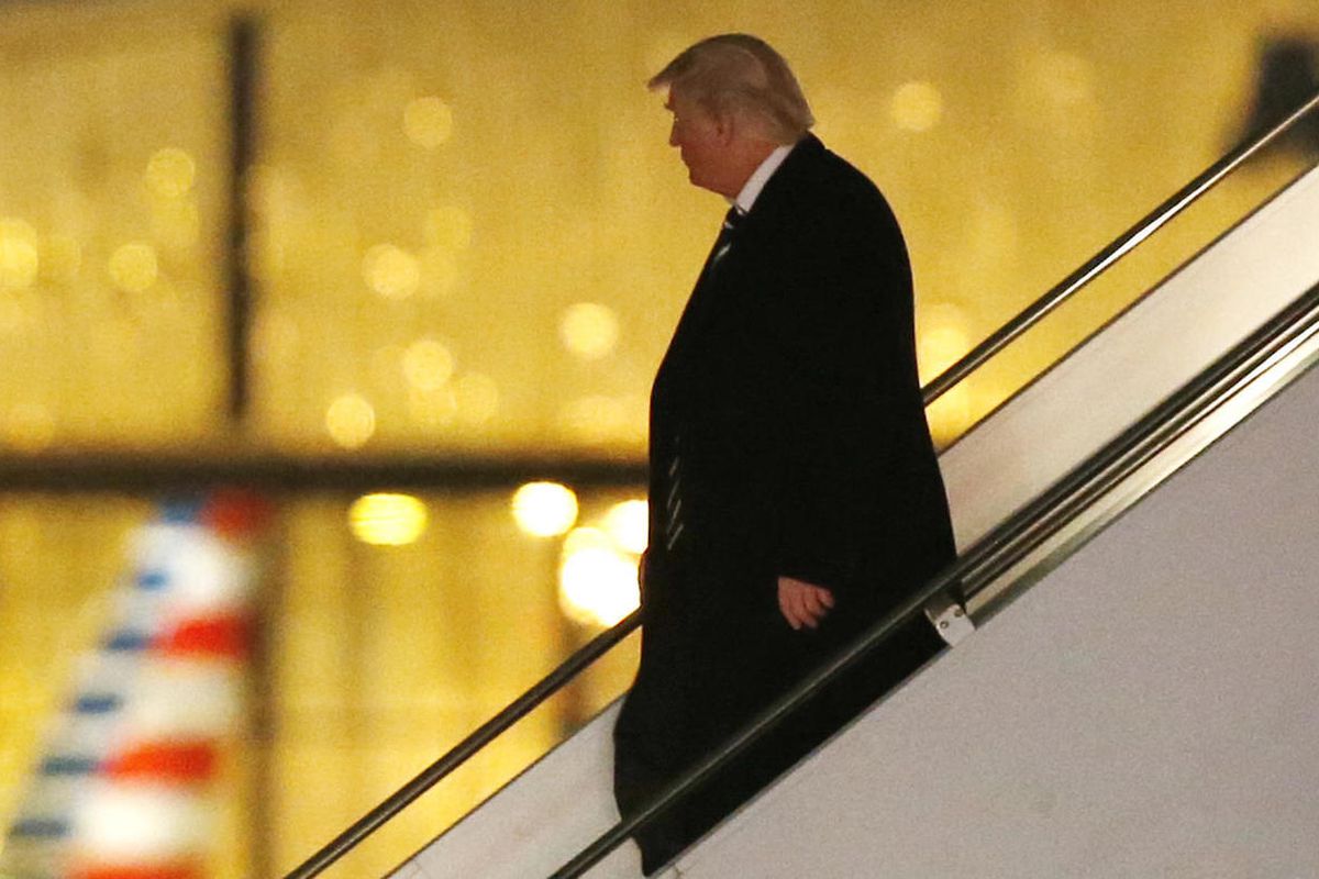 President-elect Donald Trump walks down the stairs from his plane after returning from Wisconsin to LaGuardia Airport, Tuesday, Dec. 13, 2016, in New York. 