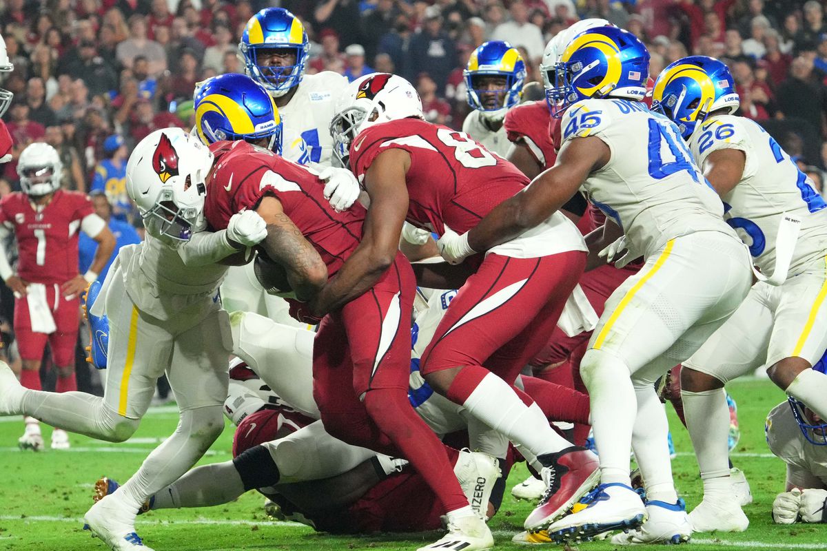 Arizona Cardinals running back James Conner (6) carries the pile forward for a touchdown against the Los Angeles Rams during the fourth quarter at State Farm Stadium.