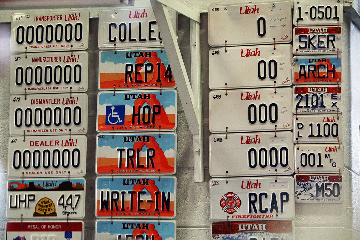 FILE - License plates on the wall in an area where the plates are manufactured at the Utah State Prison in Draper, Wednesday, March 5, 2014. At least four new specialty license plate bills are expected to be considered by state lawmakers during the 2016 L