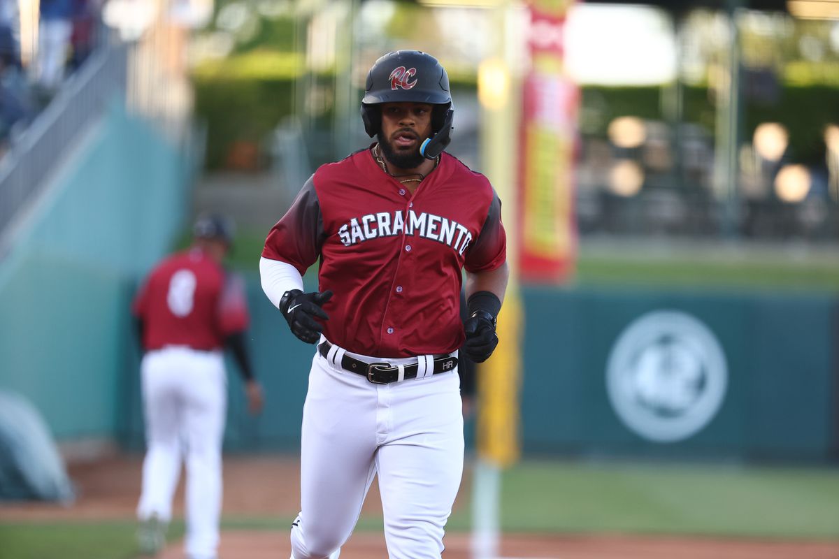 Heliot Ramos jogging while wearing a batting helmet