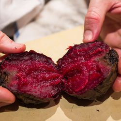 Once grilled, the beets are halved, revealing the distinct textural contrast between the interior and the crust.