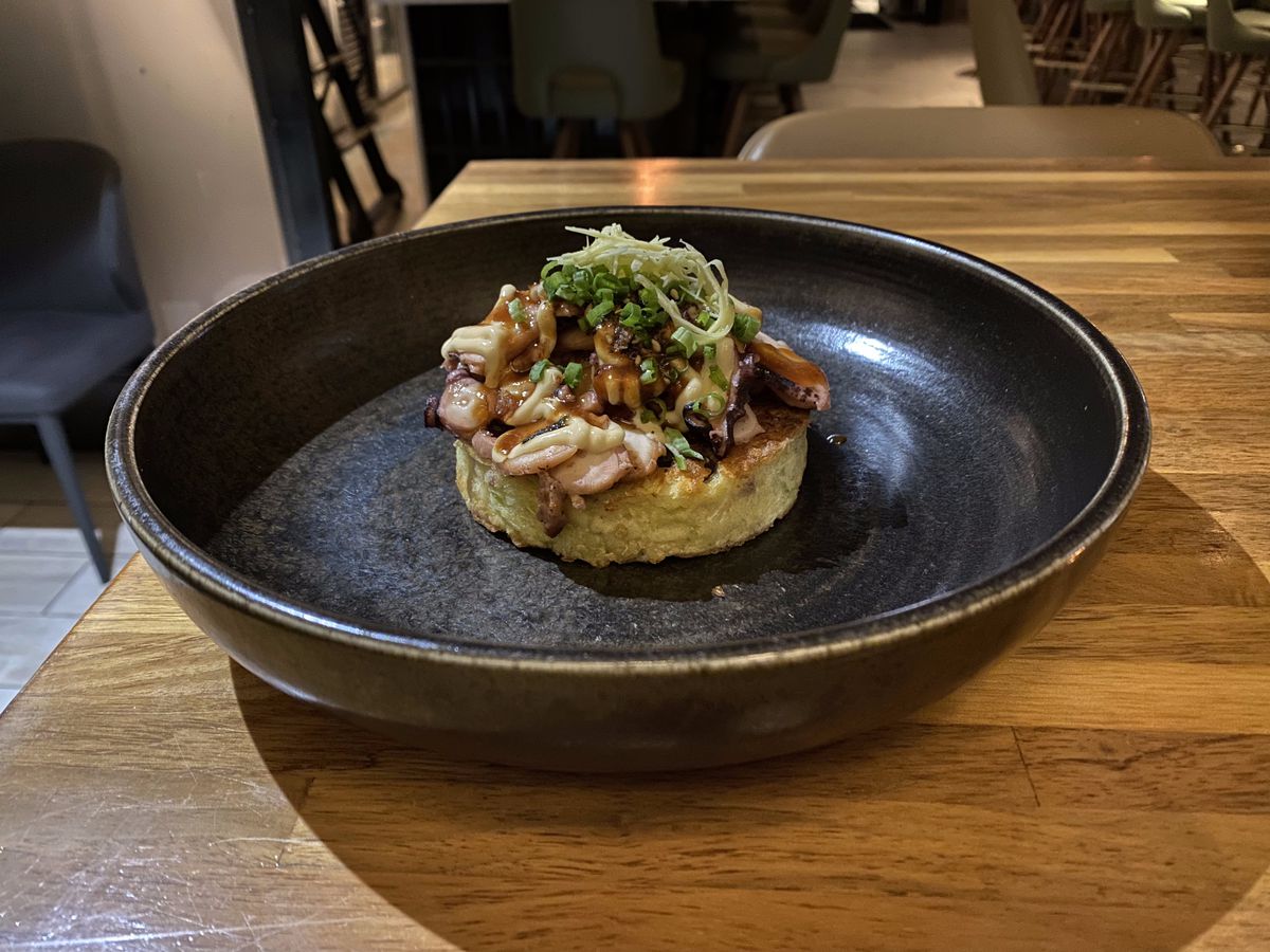 1751 Sea and Bar’s octopus okonomiyaki, octopus topped with mirin, mayo, and pickled ginger, over a cabbage bacon hot cake.