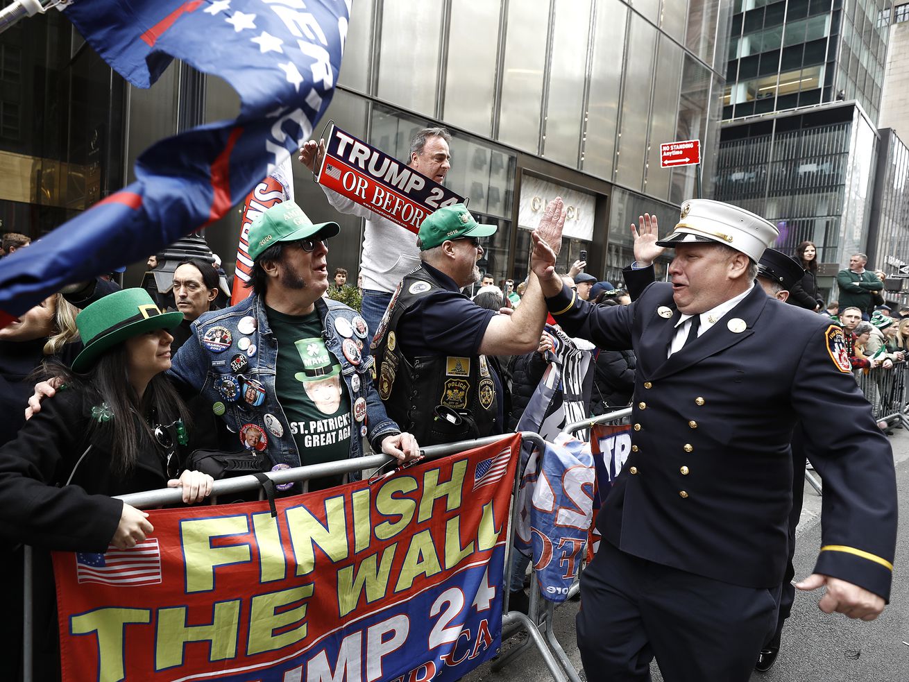 A handful of Trump supporters stand behind crowd barricades at the St. Patrick’s Day Parade on 5th Ave. in Manhattan.