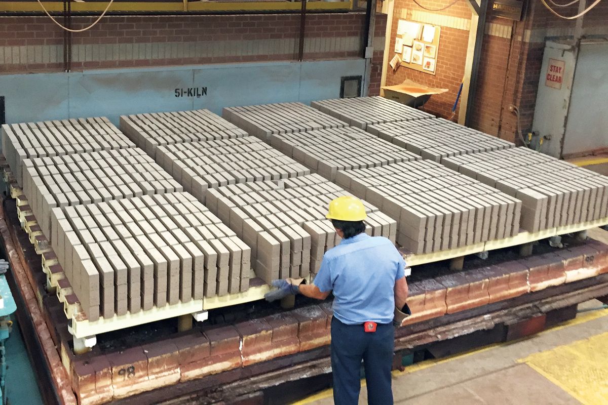 A man prepping bricks in a factory