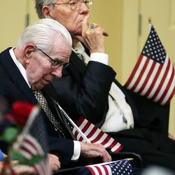 Veterans Kent Miner, front, and Donald Abraham listen during a ceremony honoring veterans at Highland Glen Senior Living Center and Memory Care in Highland on Wednesday, Nov. 9, 2016.