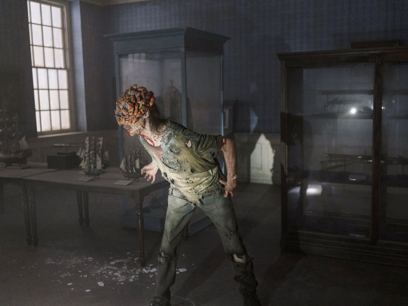 An image from the HBO show, The Last Of Us, showing a person with a fungal rot emerging from their head.