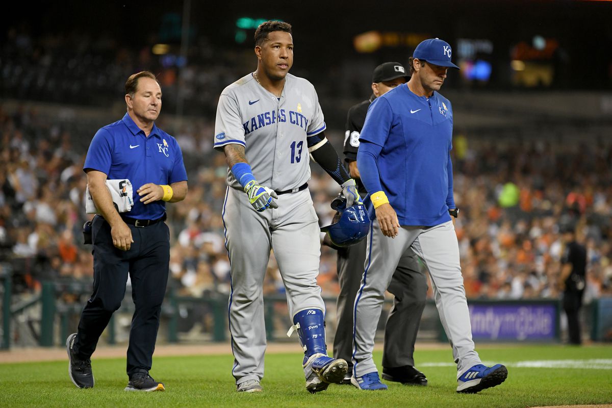 Salvador Perez walks off the field after being hit on the hand by a pitch