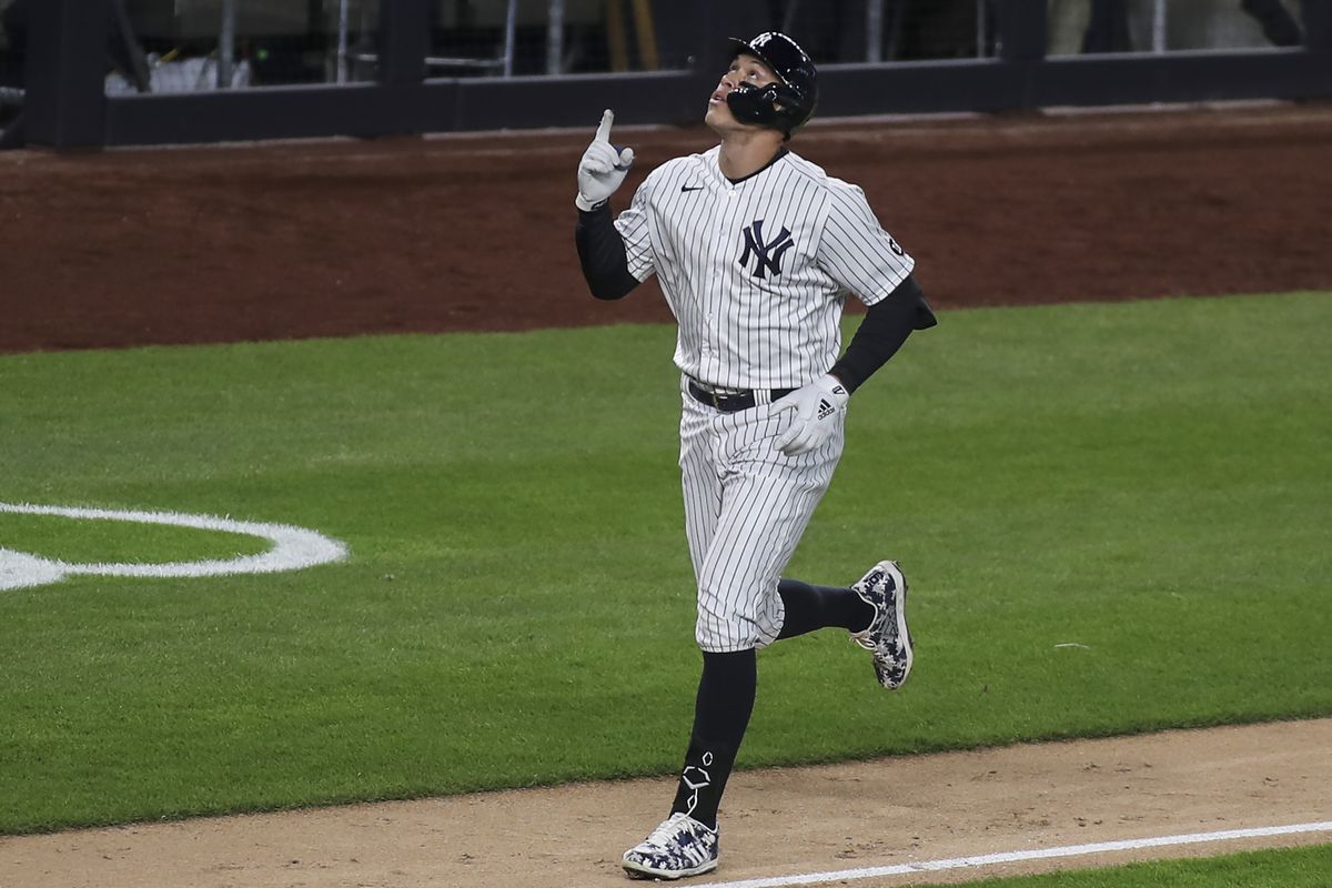 New York Yankees right fielder Aaron Judge points to the sky after hitting a three-run home run in the eighth inning against the Baltimore Orioles at Yankee Stadium.