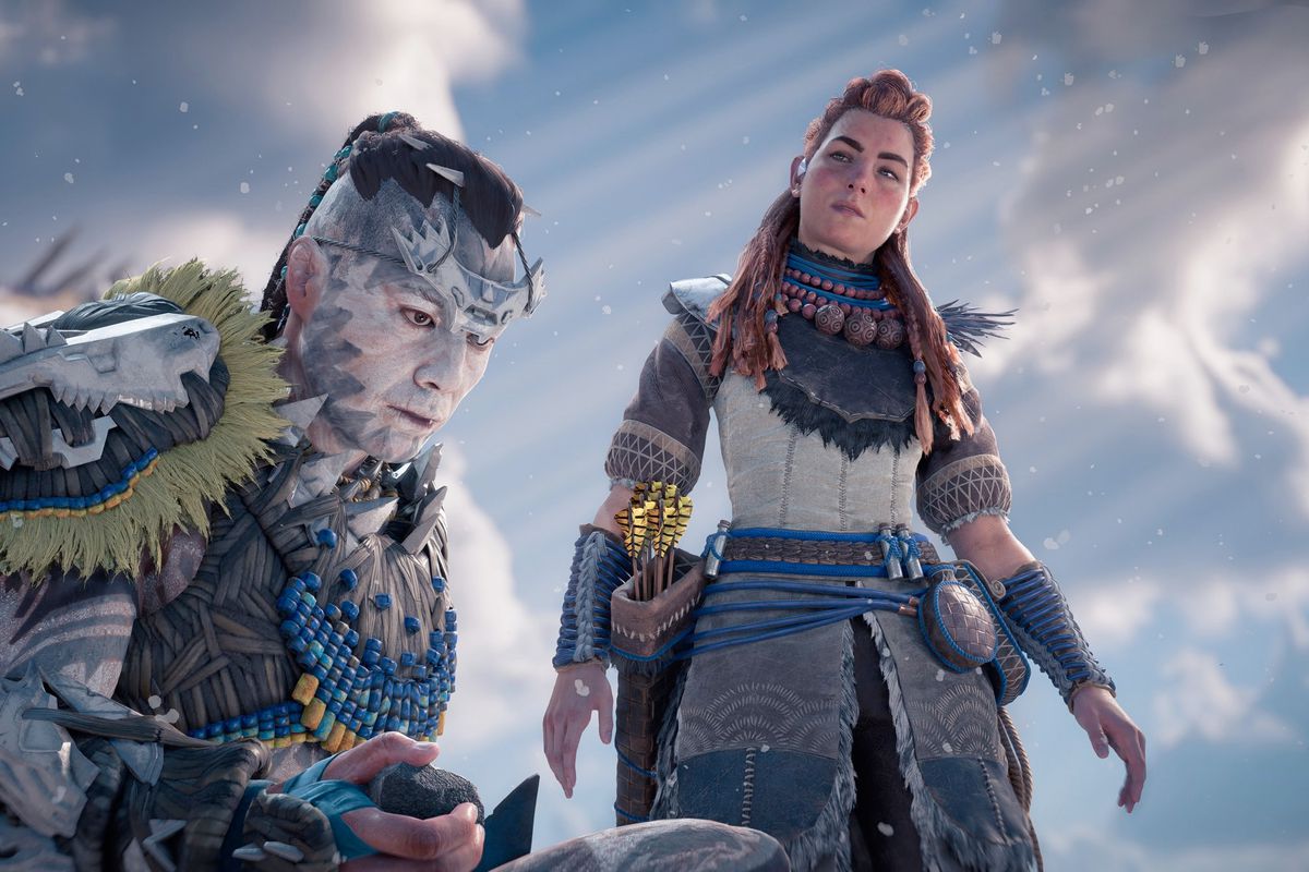 Aloy and another character from Horizon Forbidden West stand in the snow