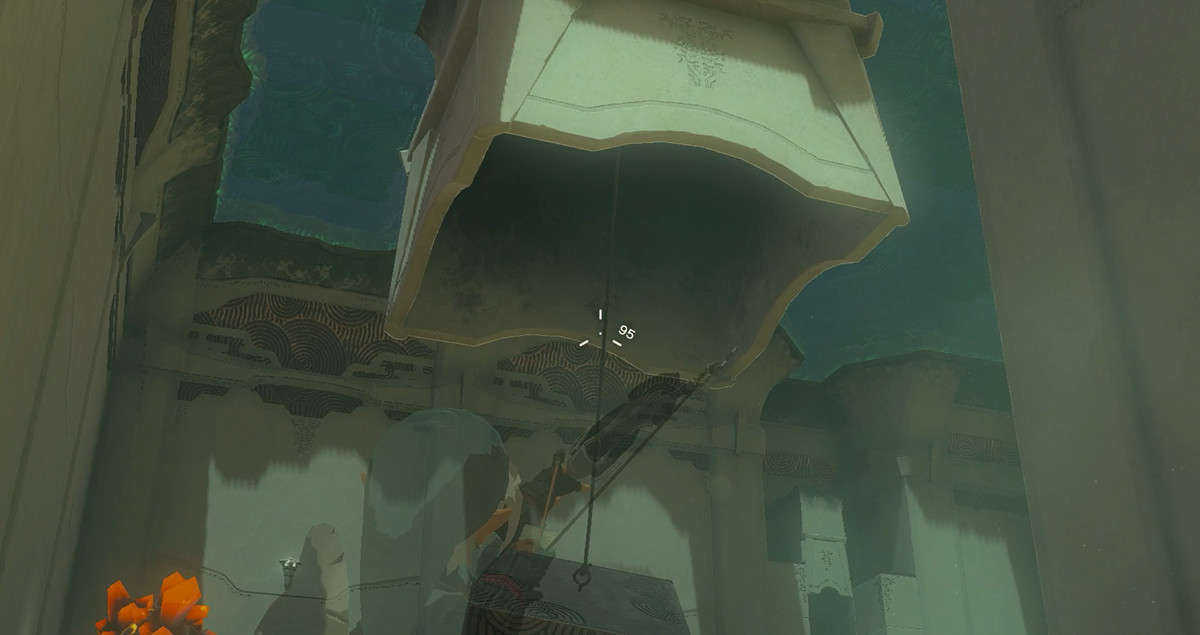 Link aiming an arrow at a rope hanging from the ceiling in Zelda: Tears of the Kingdom.