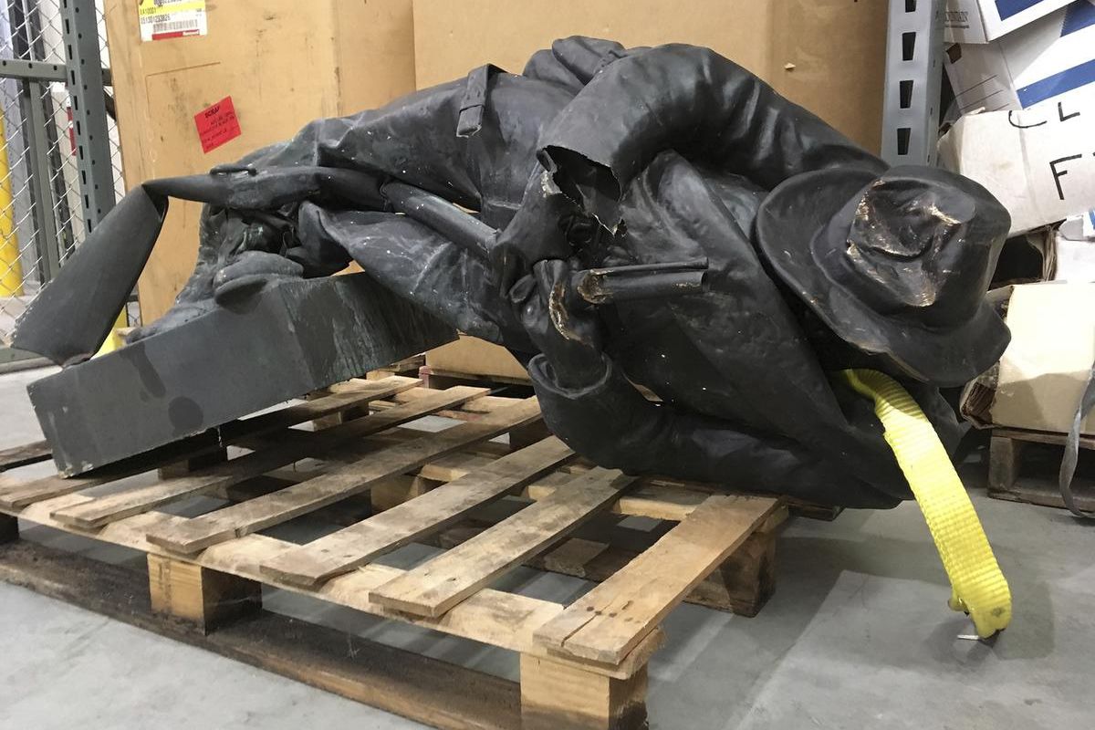 A damaged nearly century-old Confederate statue lies on a pallet in a warehouse in Durham, N.C. on Tuesday, Aug. 15, 2017. Investigators are working to identify and charge protesters who toppled the Confederate statue in front of a North Carolina governme
