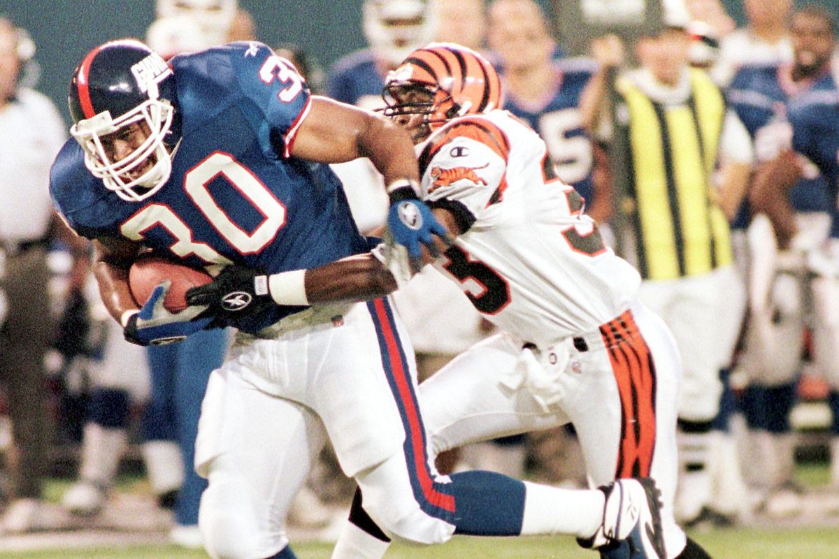 New York Giants’ Charles Way (L) is tackled by the