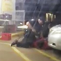 FILE - In this Tuesday, July 5, 2016 image made from video, Alton Sterling is restrained by two Baton Rouge police officers, one holding a gun, outside a convenience store in Baton Rouge, La. Moments later, one of the officers shot and killed Sterling, a black man who had been selling CDs outside the store, while he was on the ground. A day later, a white police officer shot and killed Philando Castile during a traffic stop in a suburb of Minneapolis. Coming after several similar cases in recent years, the killings rekindled debate over policing practices and the Black Lives Matter movement.