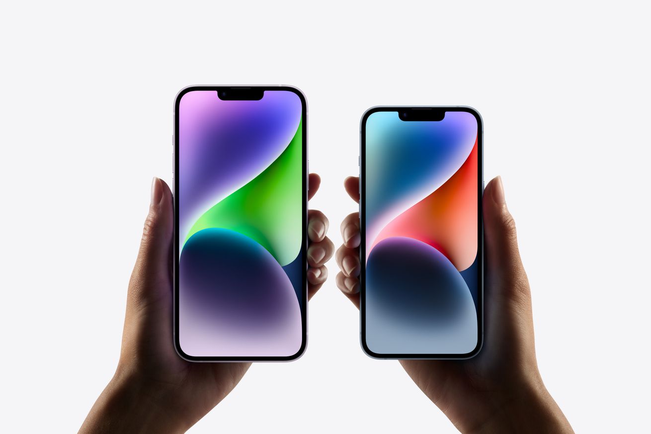 iPhone 14 and iPhone 14 Plus being held up, with screens displaying a colorful wallpaper.
