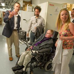 In this photo provided by Cedars-Sinai, Clive Svendsen, PhD, left, director of the Cedars-Sinai Regenerative Medicine Institute, leads Stephen Hawking, third from left, on a tour of the Regenerative Medicine Institute at Cedars-Sinai Medical Center in Los Angeles on Tuesday, April 9, 2013. Others are unidentified. 