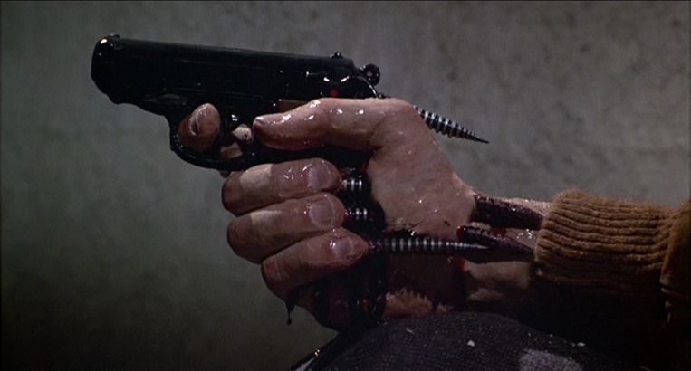 James Woods holds a gun attached to his hand in Videodrome