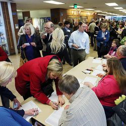 Voters check in before the Utah Republican presidential preference caucus at Brighton High School in Cottonwood Heights on Tuesday, March 22, 2016.