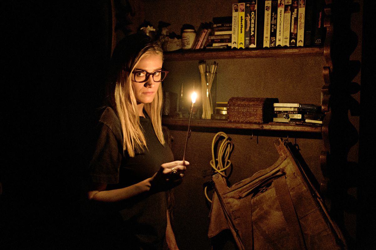 Alice digs around in a murky old library on the Syfy show “The Magicians.”