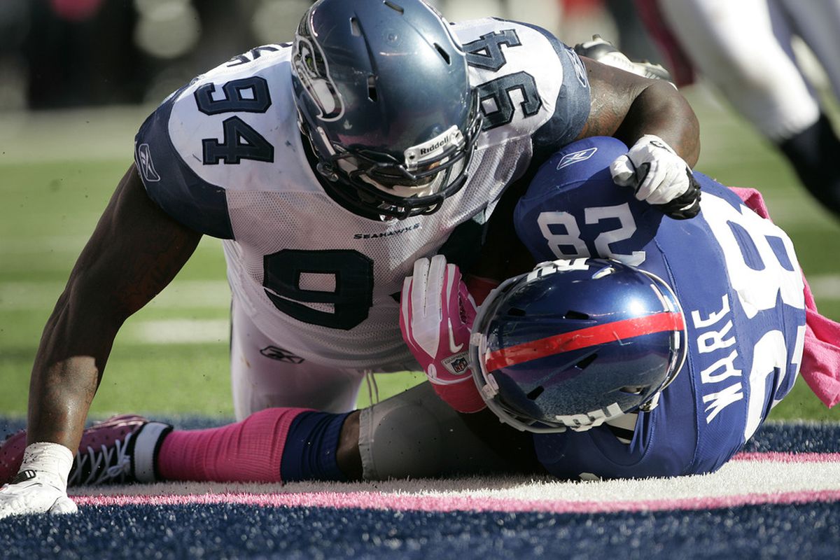 Anthony Hargrove (94) of the Seattle Seahawks tackles Danny Ware (28) of the New York Giants in the end zone for a saftey during a game at MetLife Stadium on October 9, 2011 in East Rutherford, New Jersey. (Photo by Rich Schultz /Getty Images)