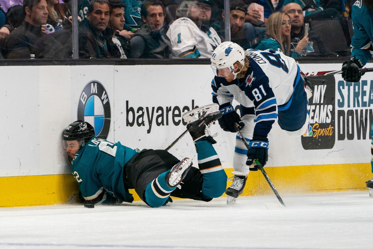 Nov 27, 2019; San Jose, CA, USA; San Jose Sharks right wing Kevin Labanc (62) is checked into the boards by Winnipeg Jets left wing Kyle Connor (81) during the second period at SAP Center at San Jose.