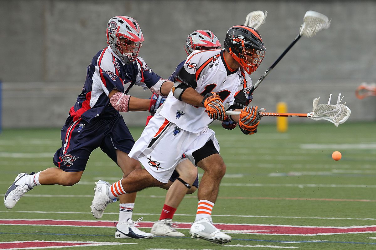 BOSTON, MA - JULY 19: Justin Pennington #14 of the Denver Outlaws beats Matt Smalley #11 of the Boston Cannons to the ball  at Harvard Stadium July 19, 2012 in Boston, Massachusetts. (Photo by Jim Rogash/Getty Images)