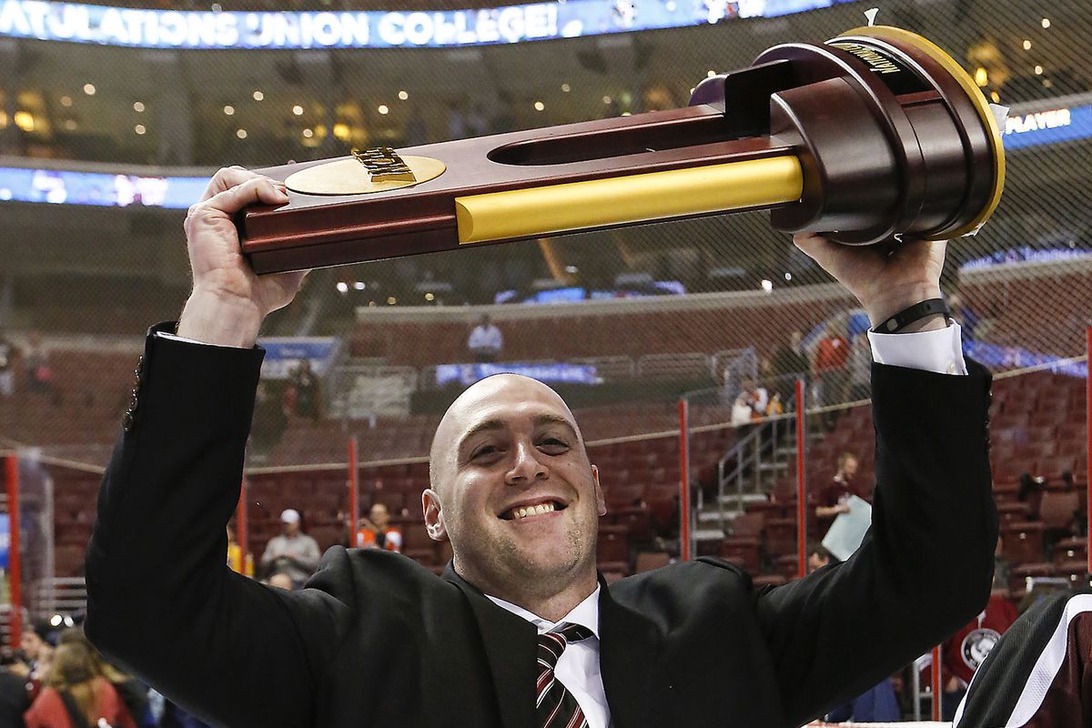 John Ronan poses with the NCAA Championship Trophy in 2014.