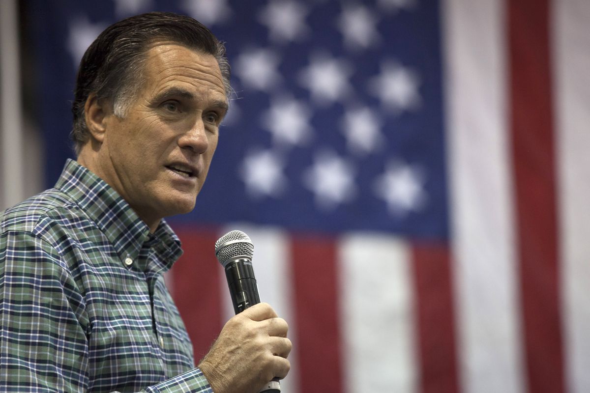 Former Massachusetts Gov. Mitt Romney addresses the crowd during a rally for Republican Senate candidate Dan Sullivan on November 3, 2014 in Anchorage, Alaska.
