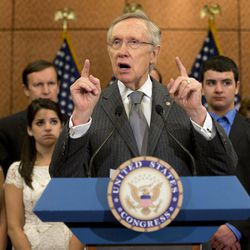 Senate Majority Leader Harry Reid of Nev., accompanied by families and friends of the Newtown, Conn. shooting victims, including siblings of Victoria Soto, Jillian Soto, left, Carlee Soto, and Carlos Soto, gestures as he speaks during a news conference on Capitol Hill in Washington, Thursday, June 13, 2013, on the six month anniversary of the Newtown shooting. 