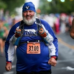 Curtis Beckstrom approaches the finish line of the Deseret News 10K at Liberty Park in Salt Lake City on Tuesday, July 24, 2018.