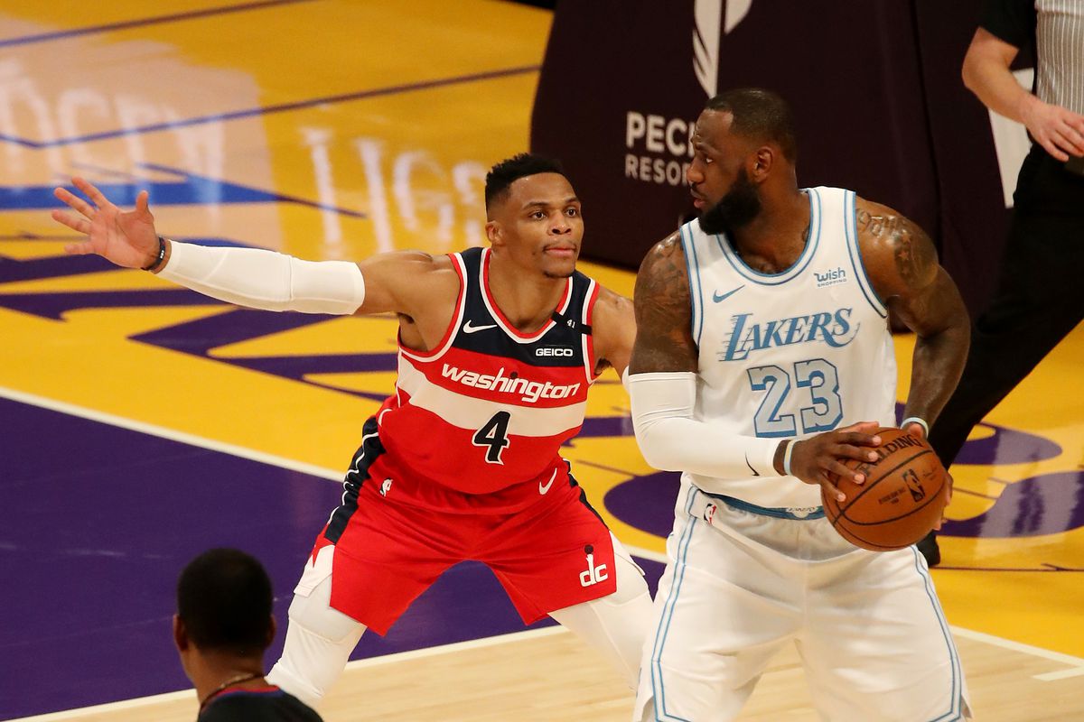 Russell Westbrook #4 of the Washington Wizards guards LeBron James #23 of the Los Angeles Lakers during the fourth quarter at Staples Center on February 22, 2021 in Los Angeles, California.&nbsp;