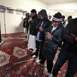 In this Jan. 8, 2016 photo, local cleric and Somali refugee Imam Said Ali, left, leads  worshippers in the weekly Friday Muslim prayer inside a makeshift mosque in Fort Morgan, a conservative farming town on the eastern plains of Colorado. From a young age, Said Ali spent most of his life living in a camp in Kenya as a refugee after his family fled the civil war in Somalia. Said Ali says that he has been made to feel welcome in the United States, and that he feels grateful to be here. 