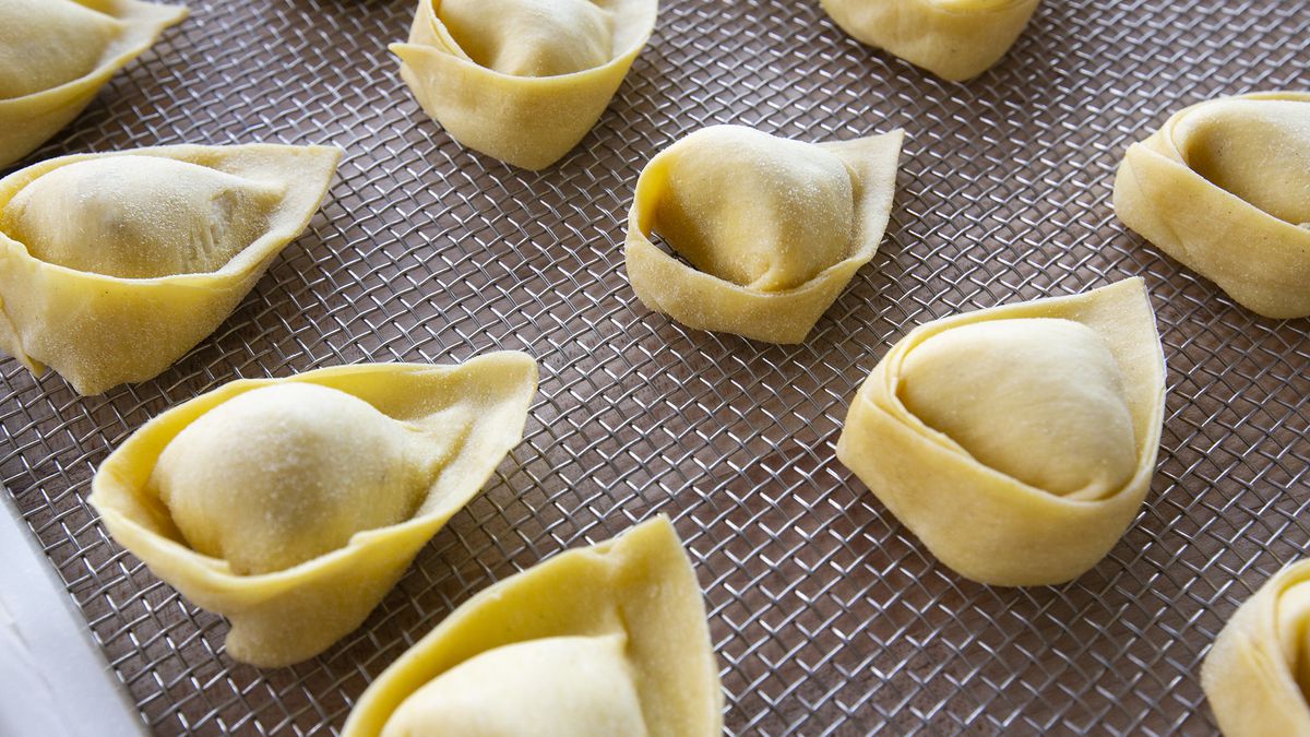 Close-up of a tray of uncooked cappelletti.