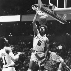 Julius "Dr. J" Erving (6) of the Sixers flies down the lane above the heads of other players and delivers a slam dunk for two of his 30 points at the NBA All-Star game in Milwaukee, Wis., Feb. 13, 1977. Erving was named MVP as the West won the game 125-124. (AP Photo)