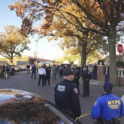 New York City Police Officers gather at a shooting scene in the Bronx borough of New York, Friday, Nov. 4, 2016. Authorities say two New York City police sergeants were shot and wounded in a gun battle with a robbery suspect. A police spokesman says the robbery suspect was killed in the gun fire exchange. 