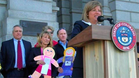 Chris Watney, president of the Colorado Children's Campaign, unveiled the 2010 Kids Count report at a Capitol news conference April 13, 2010. Behnd here, at left, are Gov. Bill Ritter and Lt. Gov. Barbara O'Brien.