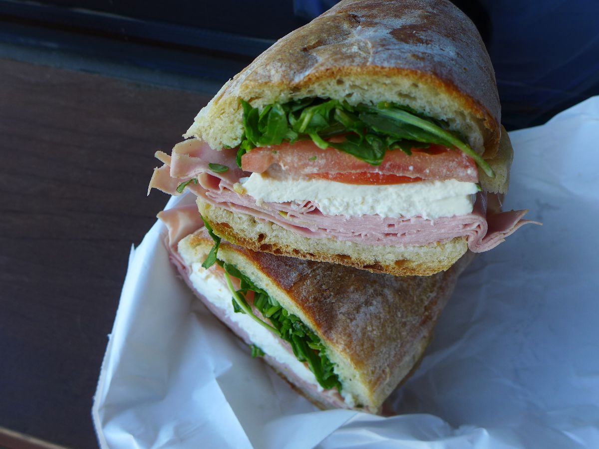 A hero sandwich with fresh mozzarella and meats.
