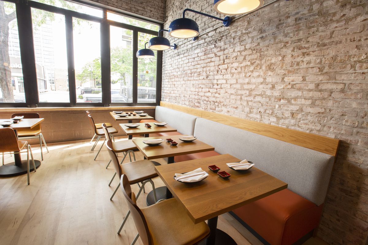 Restaurant dining room with exposed brick walls.