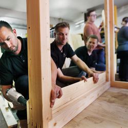 Travis Schmitt attaches a board while building a playhouse at American Fork High School in American Fork on Thursday, Nov. 10, 2016. The playhouse, built by American Fork High School and Oakwood Homes, will be sold at the Festival of Trees.