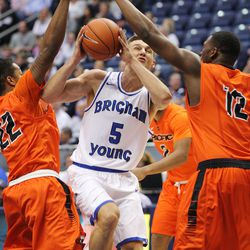 Brigham Young Cougars guard Kyle Collinsworth (5) tries to drive between Pacific Tigers guard Ray Bowles (22) and Pacific Tigers forward Eric Thompson (12) as BYU and Pacific play at the Marriott Center in Provo Utah Saturday, Feb. 6, 2016. Pacific won 77-72.