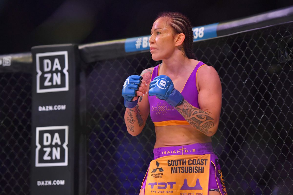 Cris Cyborg stands in the cage for her featherweight world title fight agai...