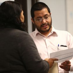 Gabriela Barrera talks with Luis Rois, a navigator at the Utah Health Policy Project, after she chose a health insurance plan in West Valley City on Wednesday, Dec. 14, 2016.