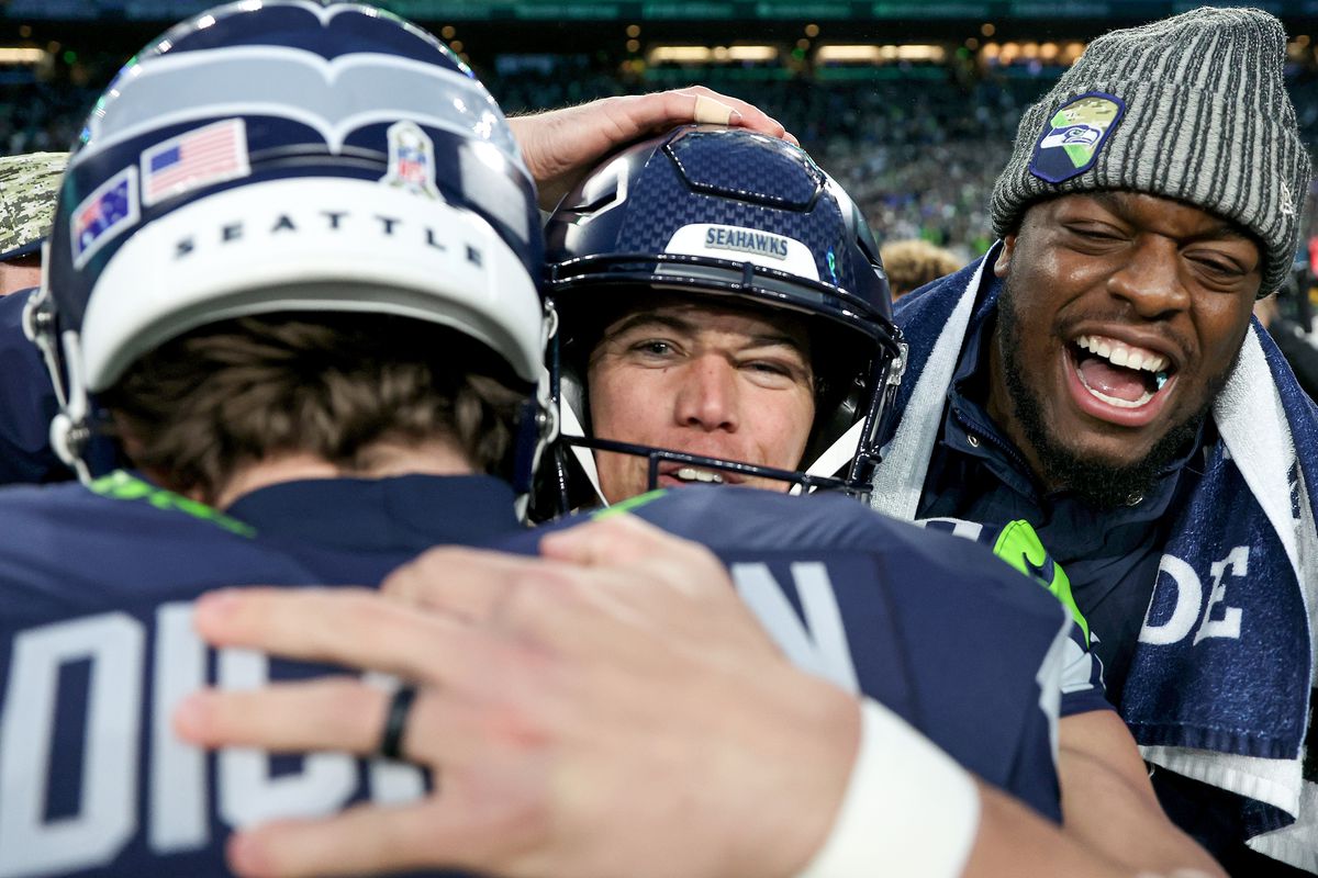 Jason Myers #5 of the Seattle Seahawks celebrates his game-winning field goal with Michael Dickson #4 against the Washington Commanders at Lumen Field on November 12, 2023 in Seattle, Washington.