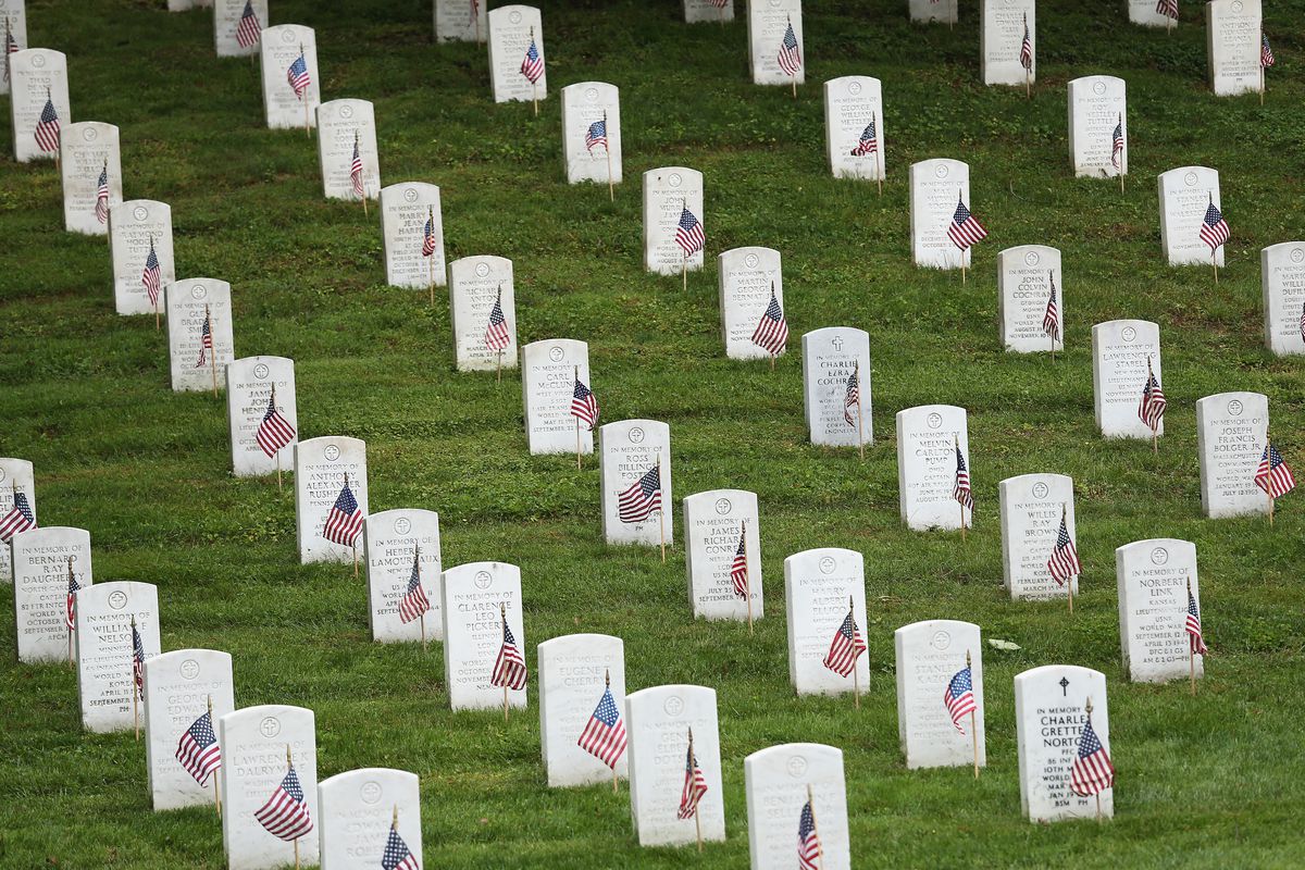 American flags placed by members of the 3rd U.S. Infantry Regiment at the graves of U.S. soldiers buried at Arlington National Cemetery, May 21, 2015.